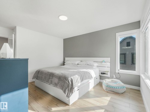 Well-lit room featuring light-toned flooring and a window providing natural light - 95 1010 Rabbit Hill Road, Edmonton, AB - Indoor Photo Showing Bedroom
