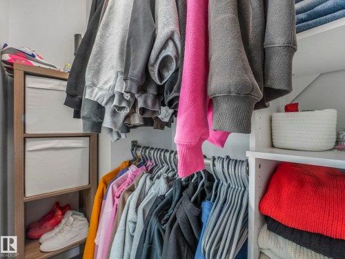 Integrated closet storage system with shelving and hanging rods - 95 1010 Rabbit Hill Road, Edmonton, AB - Indoor With Storage