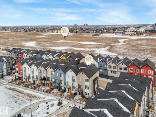 The property is part of a development featuring rows of townhomes with varying exterior colors - 95 1010 Rabbit Hill Road, Edmonton, AB - Outdoor