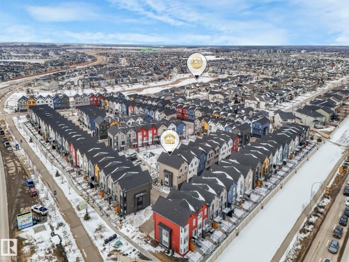 Aerial view showcasing the community with numerous properties featuring varied exterior colors and dark-colored roofs - 95 1010 Rabbit Hill Road, Edmonton, AB - Outdoor With View