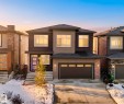 This property features a modern exterior with varied siding textures and a prominent two-car garage - 6055 King Landing Landing, Edmonton, AB  - Outdoor With Facade 