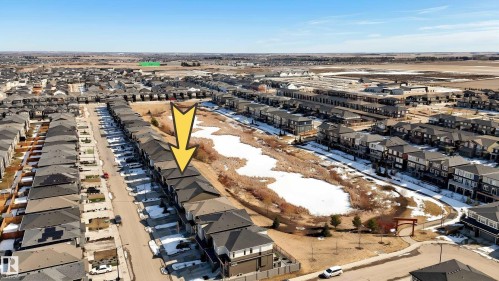 Aerial view showcasing the property situated within a structured residential area with extensive open land in the background - 6055 King Landing Landing, Edmonton, AB - Outdoor With View