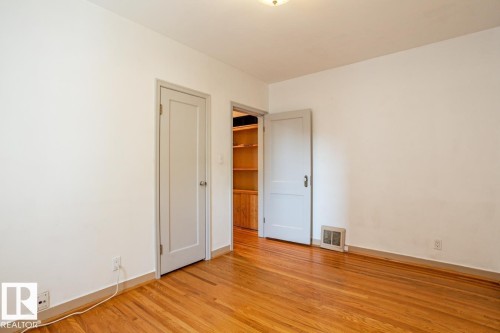 This room features hardwood floors and white walls - 8736 76 Avenue, Edmonton, AB - Indoor Photo Showing Other Room