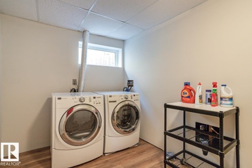 The property features a dedicated laundry area with a window, providing natural light, and a drop ceiling - 8736 76 Avenue, Edmonton, AB - Indoor Photo Showing Laundry Room