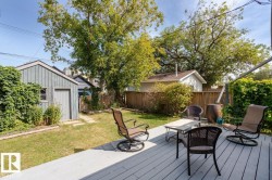 This property features a spacious yard with a well-maintained lawn and mature trees, offering a serene outdoor environment - 