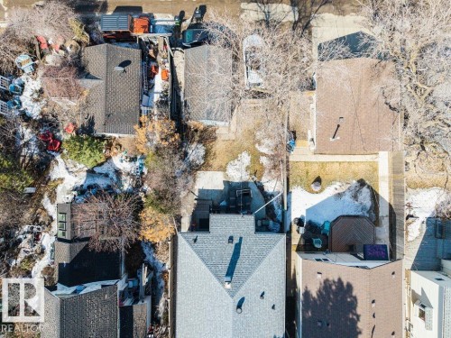 Aerial view showcasing the property's roof with a dark shingle finish and the surrounding neighborhood - 8736 76 Avenue, Edmonton, AB - Outdoor