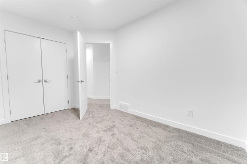 This room features light grey carpeting, white walls, and white trim - 444 Crystal Creek Link, Leduc, AB - Indoor Photo Showing Other Room