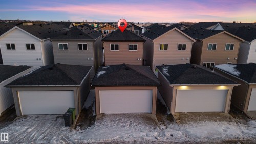 The property features a two-story home with a detached single-car garage - 444 Crystal Creek Link, Leduc, AB - Outdoor With Exterior