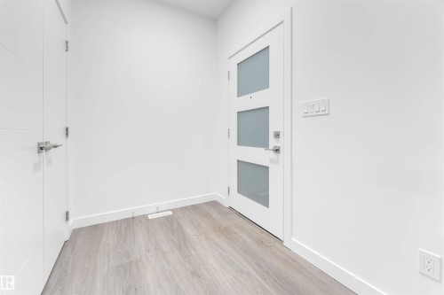 Entryway featuring light-toned flooring, white walls, and a modern door with frosted glass panels - 444 Crystal Creek Link, Leduc, AB - Indoor Photo Showing Other Room