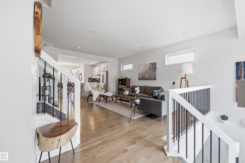 The property features an open living space with hardwood floors and recessed lighting - 7123 Cardinal Way, Edmonton, AB - Indoor Photo Showing Other Room