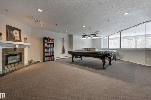 106 11915 106 Avenue, Edmonton, AB - Indoor Photo Showing Other Room With Fireplace