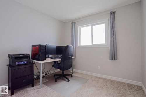 This room features light-colored walls, a window with a white frame, and carpeting - 1424 Mcconachie Boulevard, Edmonton, AB - Indoor Photo Showing Office