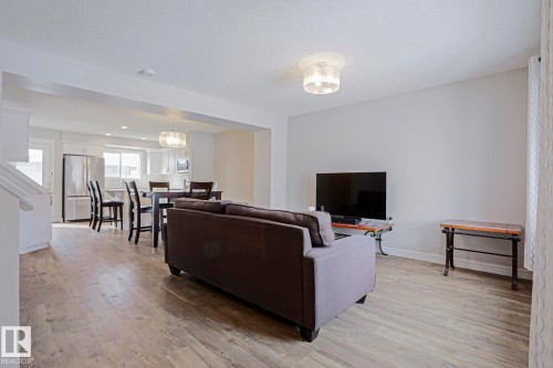 Open concept living area with light-toned flooring and a white ceiling - 1424 Mcconachie Boulevard, Edmonton, AB - Indoor