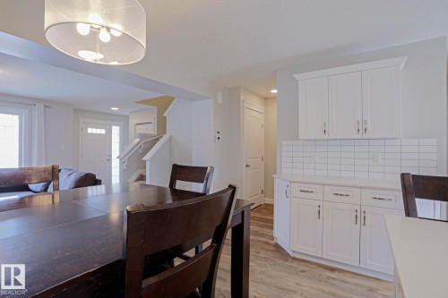 This inviting dining area features a stylish chandelier, providing ample lighting - 1424 Mcconachie Boulevard, Edmonton, AB - Indoor Photo Showing Dining Room