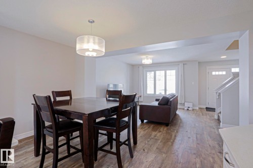 Open concept living area with light-colored walls and wood-look flooring - 1424 Mcconachie Boulevard, Edmonton, AB - Indoor Photo Showing Dining Room