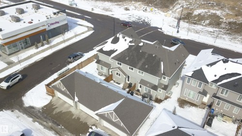 The property features a multi-story structure with a gray exterior and dark roofs - 1424 Mcconachie Boulevard, Edmonton, AB - 