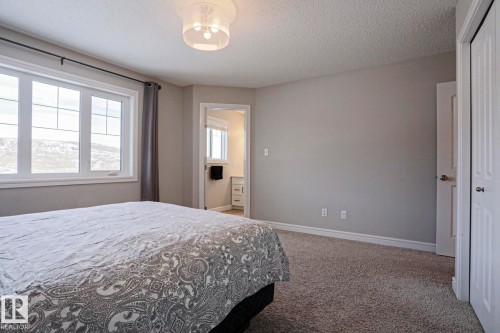 Bedroom featuring a large window with a view of the outdoors, light gray walls, and carpet flooring - 1424 Mcconachie Boulevard, Edmonton, AB - Indoor Photo Showing Bedroom