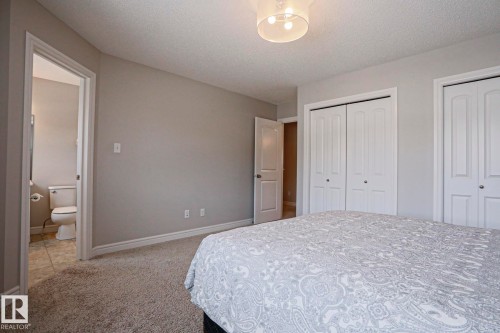 The property features soft grey walls, light-colored carpeting, and a ceiling light fixture - 1424 Mcconachie Boulevard, Edmonton, AB - Indoor Photo Showing Bedroom