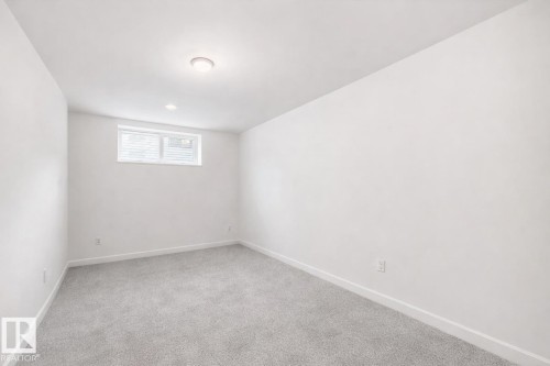 Bright room featuring white walls, light gray carpeting, and a window with blinds - 2935 Chokecherry Common, Edmonton, AB - Indoor Photo Showing Other Room