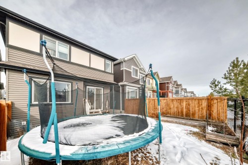 The property features a fenced backyard with a patio area and a wooden fence - 2935 Chokecherry Common, Edmonton, AB - Outdoor