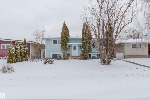 The property features a light blue exterior with white trim and a white front door - 11528 42 Avenue, Edmonton, AB - Outdoor With Facade