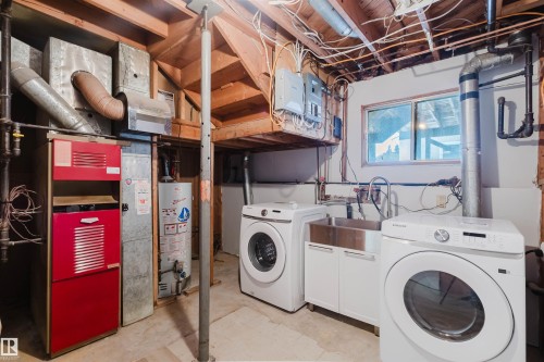 This utility area features a window, a stainless steel sink with cabinetry, and an exposed wood beam ceiling - 11528 42 Avenue, Edmonton, AB - Indoor Photo Showing Laundry Room