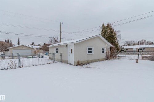 The property includes a detached building with a white exterior, a white door, and two windows - 11528 42 Avenue, Edmonton, AB - Outdoor With Exterior