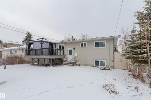 The property features an elevated rear deck with a gazebo, accessible via outdoor stairs - 11528 42 Avenue, Edmonton, AB - Outdoor