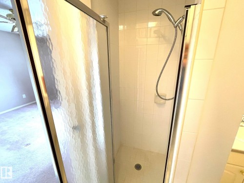 Bathroom featuring a tiled shower with a glass enclosure and a handheld shower head - 44 Arlington Drive, St. Albert, AB - Indoor Photo Showing Bathroom