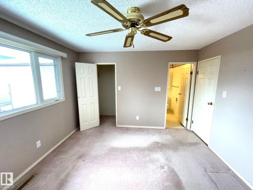 This room features neutral-toned walls, a ceiling fan, and carpeted floors - 44 Arlington Drive, St. Albert, AB - Indoor Photo Showing Other Room