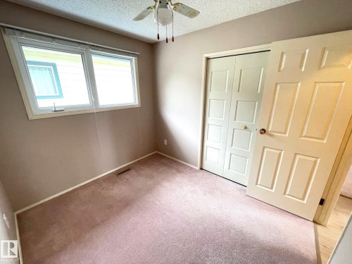 This room features a window providing natural light, carpeted flooring, and a ceiling fan - 44 Arlington Drive, St. Albert, AB - Indoor Photo Showing Other Room