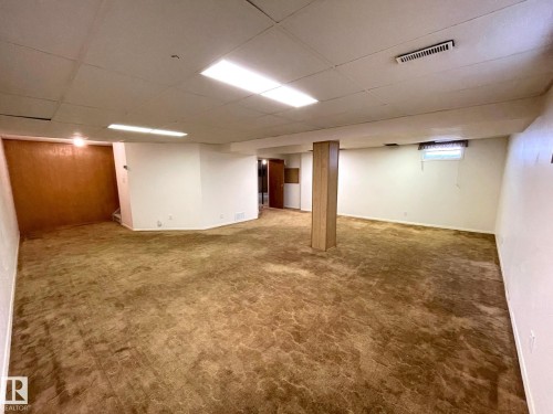 Spacious room with overhead lighting, a drop ceiling, and a window - 44 Arlington Drive, St. Albert, AB - Indoor Photo Showing Basement