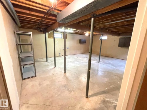 The property features a spacious unfinished basement with exposed wooden beams, concrete floors, and partial wall finishes - 44 Arlington Drive, St. Albert, AB - Indoor Photo Showing Basement