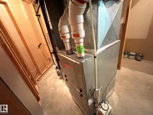 This property features a furnace with associated ductwork and piping, situated on a concrete floor - 44 Arlington Drive, St. Albert, AB - Indoor Photo Showing Other Room