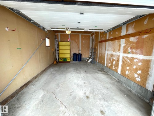 Spacious garage with a concrete floor and overhead garage door - 44 Arlington Drive, St. Albert, AB - Indoor Photo Showing Garage