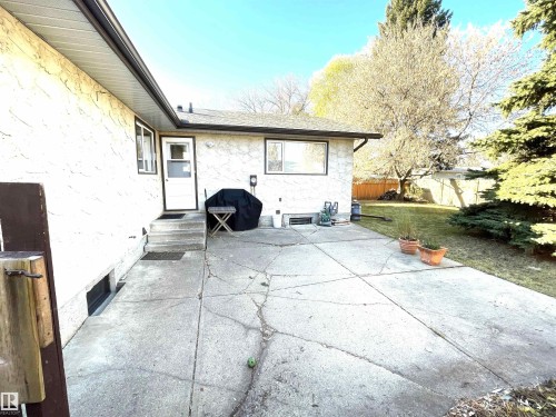 The property features a concrete patio area with steps leading to an exterior door - 44 Arlington Drive, St. Albert, AB - Outdoor
