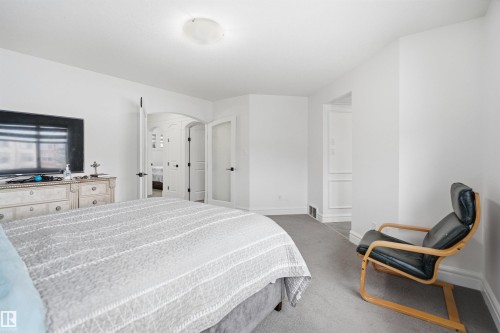 The property features a bright room with white walls and grey carpeting - 469 Ainslie Crescent Sw, Edmonton, AB - Indoor Photo Showing Bedroom