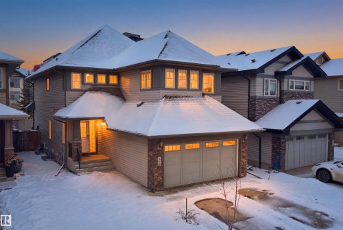 The property features a two-story design with a front-facing attached garage - 469 Ainslie Crescent Sw, Edmonton, AB - Outdoor