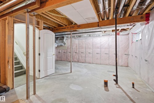 Unfinished basement with exposed wooden beams, concrete floor, and insulated walls - 469 Ainslie Crescent Sw, Edmonton, AB - Indoor Photo Showing Basement