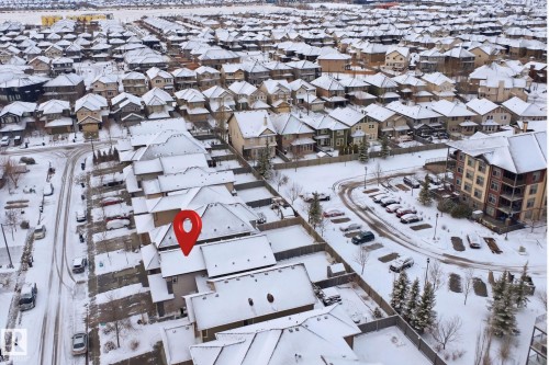 Aerial view of the property and surrounding neighborhood, featuring a residential area with varied housing styles and an apartment building - 469 Ainslie Crescent Sw, Edmonton, AB - Outdoor