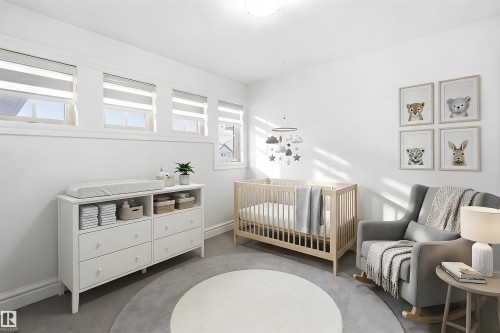 This room features white walls, four windows with blinds, and a light-colored round area rug over gray carpeting - 469 Ainslie Crescent Sw, Edmonton, AB - Indoor Photo Showing Bedroom