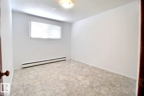 Room featuring light-colored flooring, white walls, and a window with blinds - 5109 49 Avenue, Andrew, AB - Indoor Photo Showing Other Room