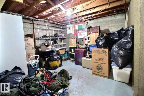 The property features an unfinished basement with exposed ceiling joists and concrete block walls - 5109 49 Avenue, Andrew, AB - Indoor Photo Showing Basement
