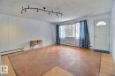 This interior space features light-colored walls and a parquet floor - 5109 49 Avenue, Andrew, AB  - Indoor Photo Showing Other Room 