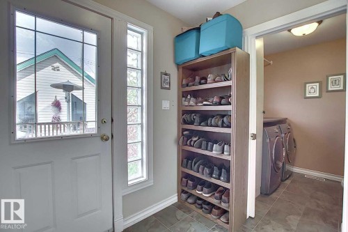 Entryway with tile flooring and a side window, providing natural light - 11126 52 Street, Edmonton, AB - Indoor