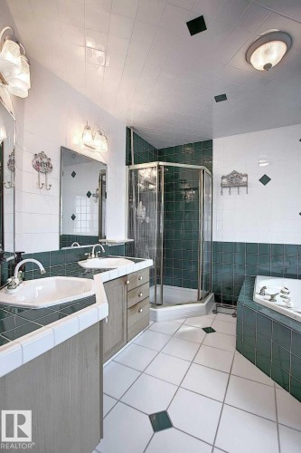 Bathroom featuring a corner shower, a built-in bathtub, and a double vanity with two sinks - 11126 52 Street, Edmonton, AB - Indoor Photo Showing Bathroom