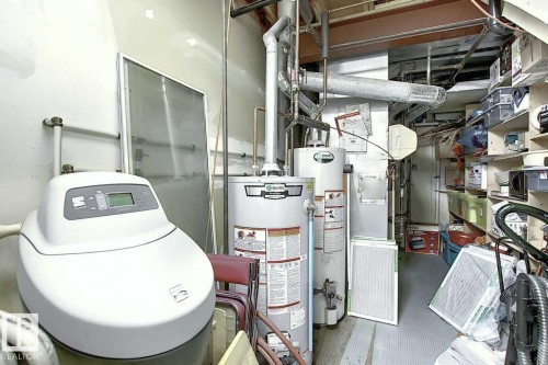 Utility room featuring water heaters and a water softener - 11126 52 Street, Edmonton, AB - Indoor