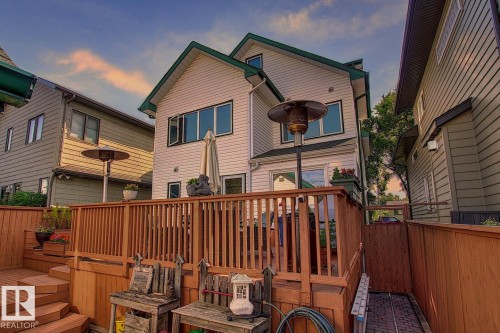 The property features a multi-level wooden deck with a wooden railing and steps - 11126 52 Street, Edmonton, AB - Outdoor With Exterior