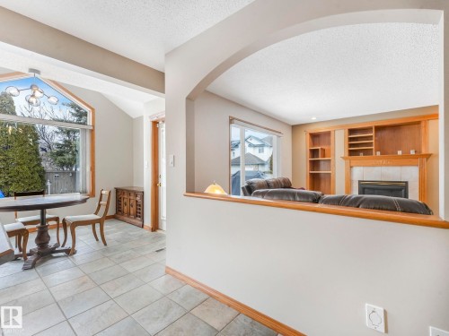 This property features a dining area with tiled flooring and a large window, providing natural light - 11704 11 Avenue, Edmonton, AB - Indoor With Fireplace