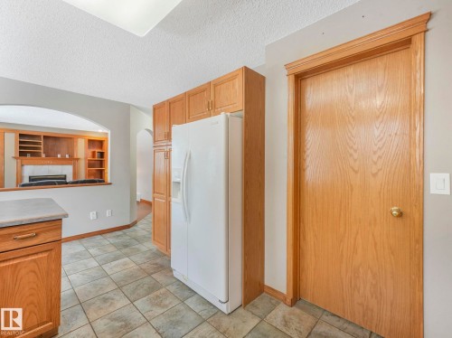 Kitchen area with tile flooring and wood cabinetry - 11704 11 Avenue, Edmonton, AB - Indoor Photo Showing Kitchen